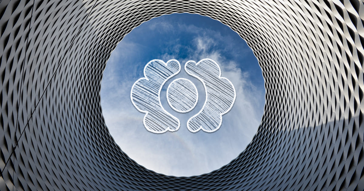 Photo illustration of CloudCannon logo and an upward view of a building resembling a giant eye