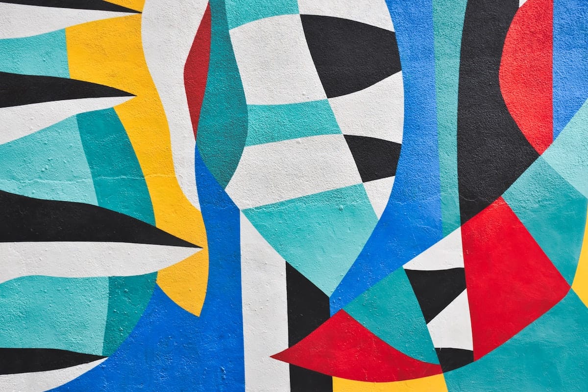 a close up of colourful street art with large colour-blocked abstract shapes.