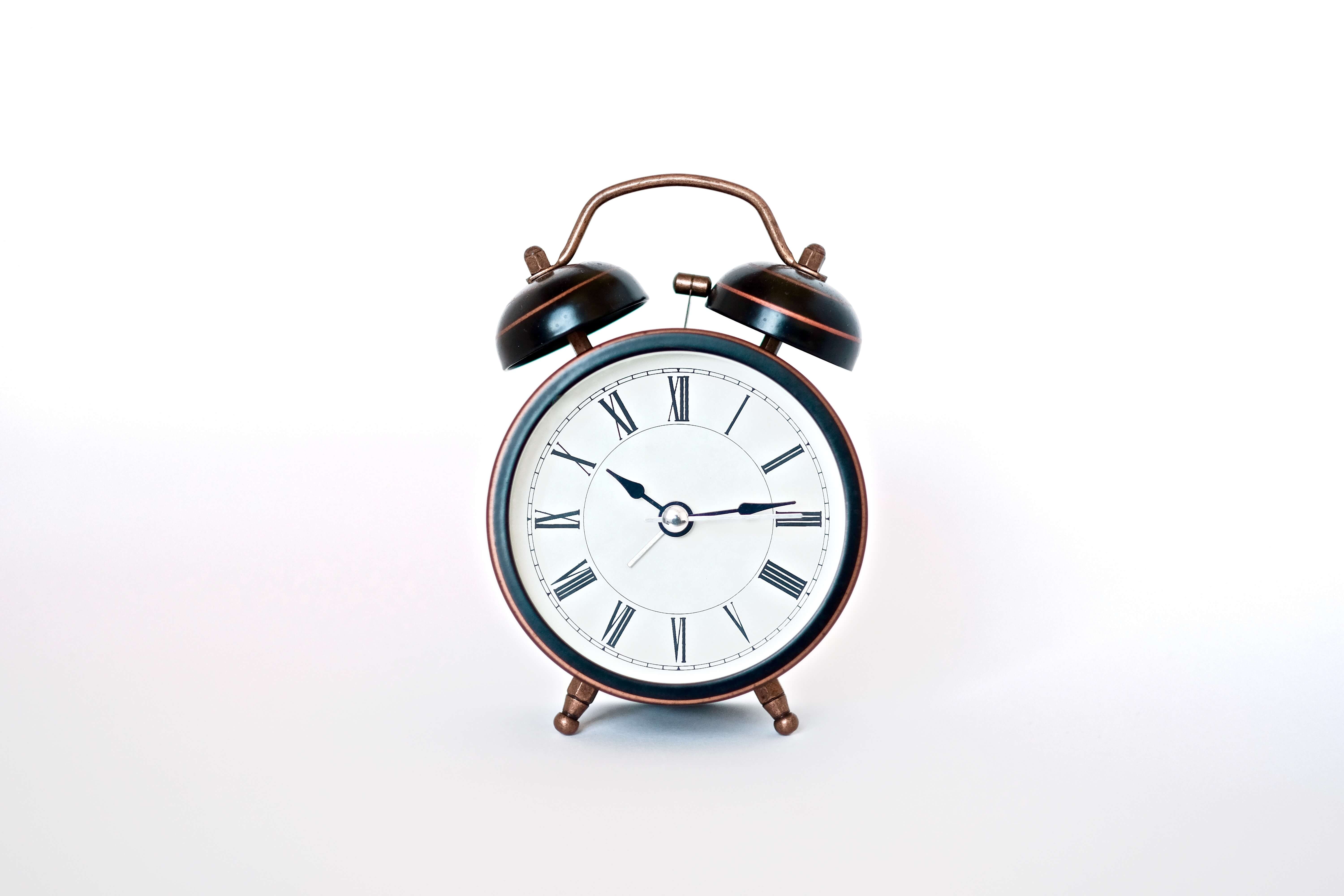 classic alarm clock with white background