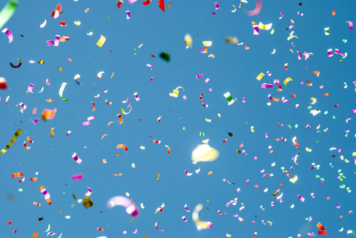 blue background with sprinkled colourful confetti