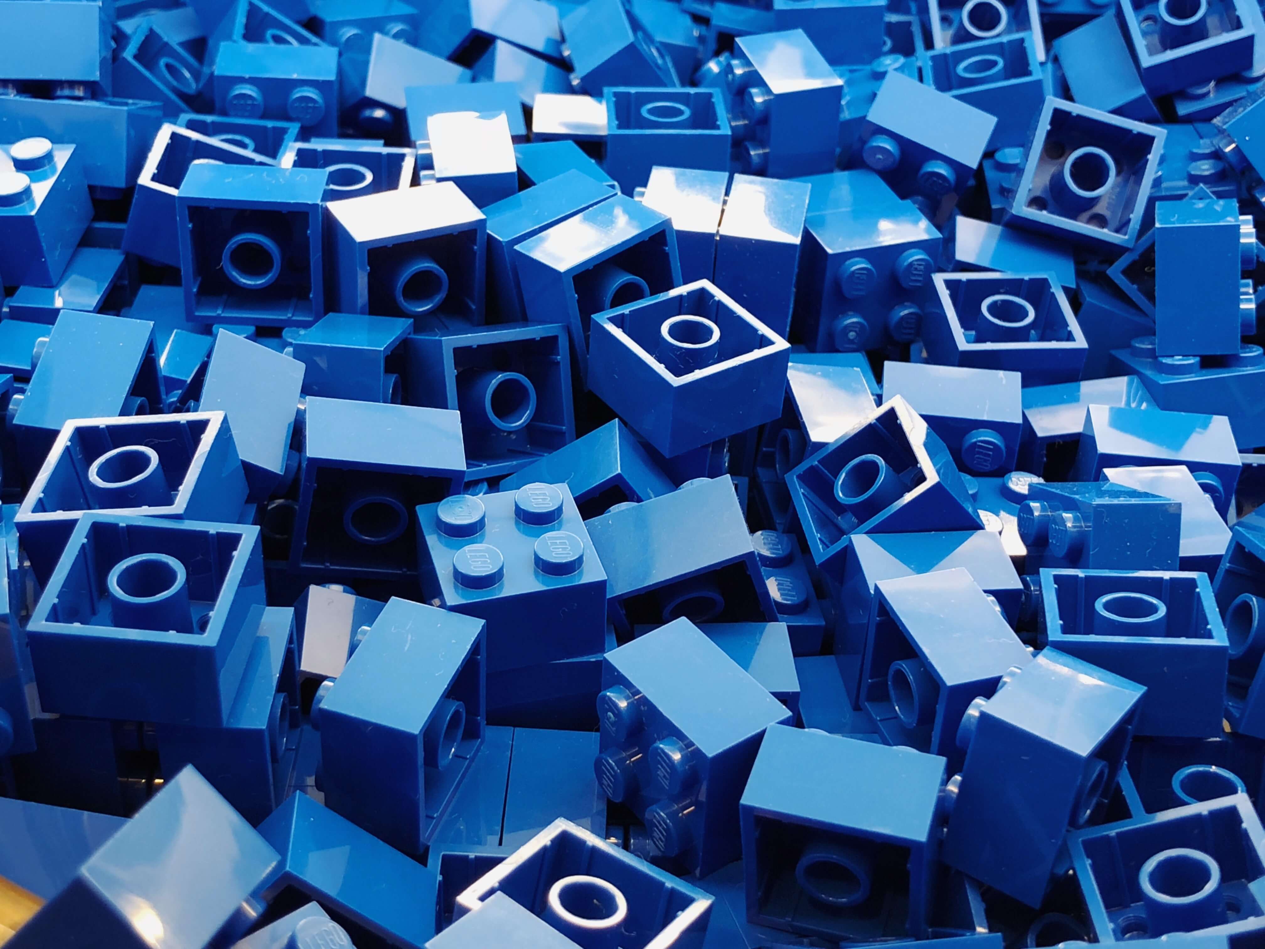 close up of a pile of blue 4-by-4 lego pieces