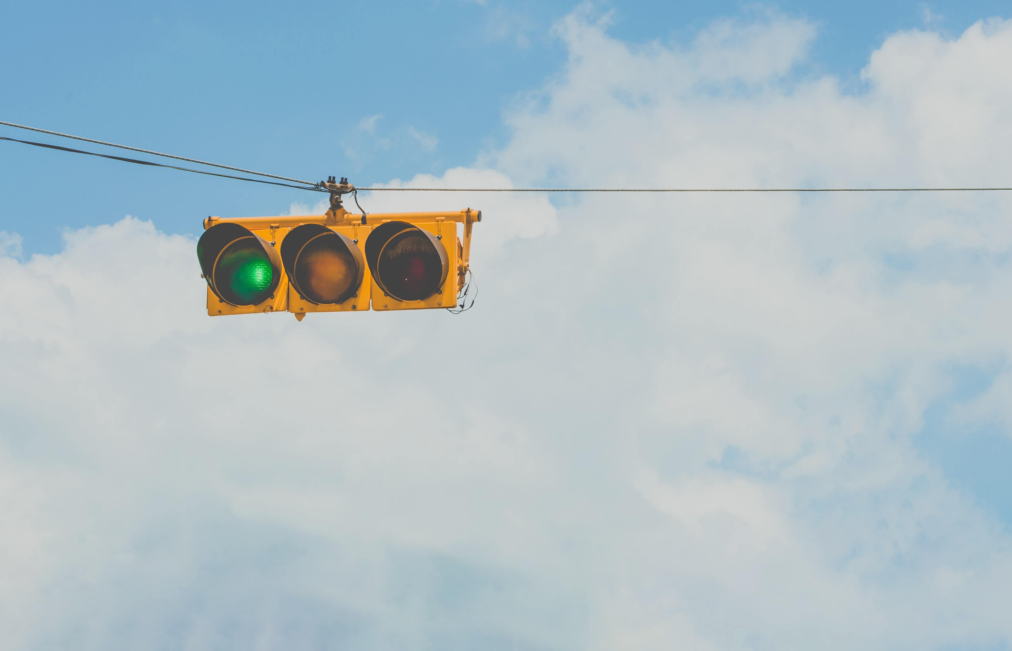 traffic lights suspended horizontally with electrical wires